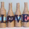 gift for the wine lover: set of 4 wine bottle vases on shelf with "love"