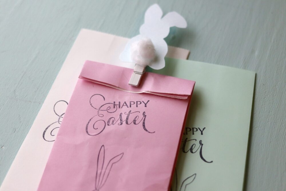 set of 3 Happy Easter Bags in 3 colors with bunny clip on teal background