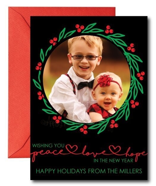 black holiday card with red and green on white background with red envelope